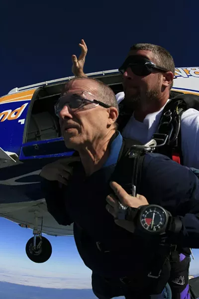 Up in arms: The writer (left) on his virgin jump with instructor Bob Crossman - MICAH COUCH, COURTESY SKYDIVE DELAND