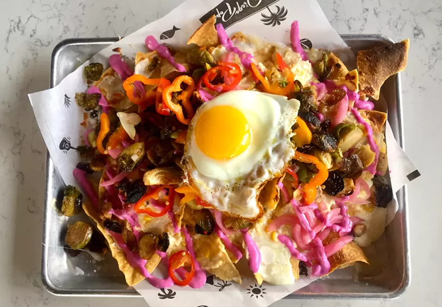 A pop of pink roasted garlic beet crème tops the Brussels sprouts nachos at Diego Pops. - ALLISON YOUNG