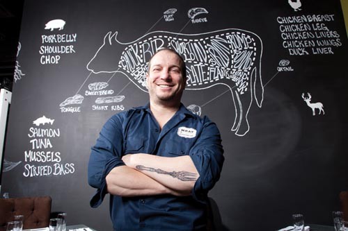 A cut above: Chef Richard DeShantz, with his chalkboard of meat. - PHOTO BY BRIAN KALDORF
