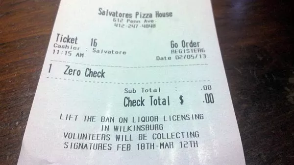 A receipt at Salvatore's Pizza House urges Wilkinsburg residents to "lift the ban on liquor licensing." - PHOTO BY AMYJO BROWN