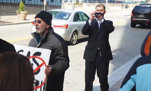 A representative from environmental-consulting group TeemCo videotapes protesters for an online newsletter. - LAUREN DALEY