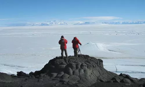 At the top of the bottom of the world: Director Werner Herzog and cinematographer Peter Zeitlinger survey Antarctica.