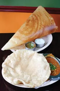 Channa batura, fried "puffy bread" served with chickpeas in a spiced tomato sauce, and a dosai with samber and chutney - HEATHER MULL