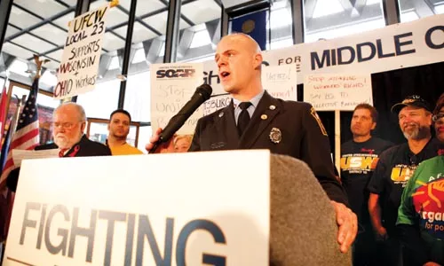 Darrin Kelly, a trustee for the Pittsburgh firefighters' union, speaks to the crowd at a Feb. 24 labor rally. - HEATHER MULL
