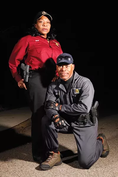 Dave Adams, in the Conscience Group's tactical suit, and Marie Blair in the group's standard uniform - PHOTO BY HEATHER MULL