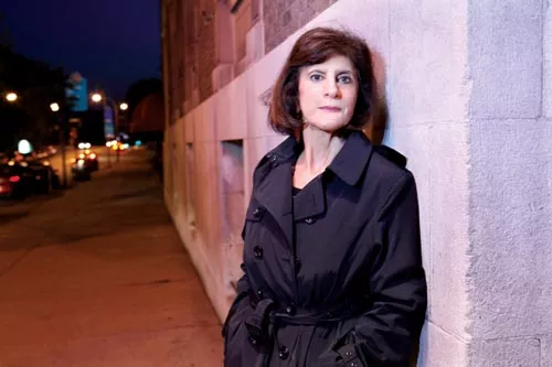 Detective author Kathleen George, trench-coated, has just published her fifth thriller, Hideout. - PHOTO BY HEATHER MULL