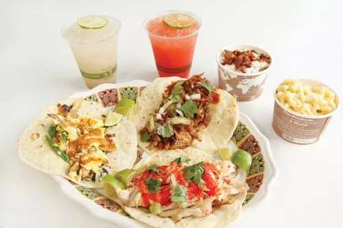 From left, egg, barbecued rib and chicken tacos, with drinks (horchata and watermelon agua fresco) and sides (potato salad and mac-and-cheese) - PHOTO BY HEATHER MULL