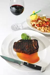 Kansas City sirloin steak with pan-fried calamari and hot cherry peppers - HEATHER MULL