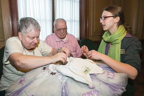 Marty Mathews examines a costume as she and Maurice Johnston take a PBT sensory seminar with the Alyssa Herzog Melby.