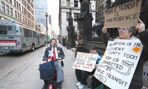 Members of Save Our Transit rally Downtown for bus service. - PHOTO BY HEATHER MULL