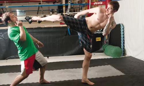 MMA Instructor Jimmy Cerra, left, with a student, says the martial-arts industry needs to take an active role in policing itself. - CAROLINE MOORE