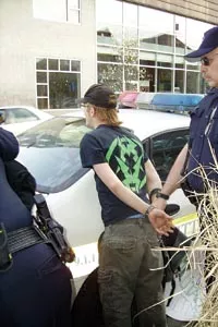 Noah Willumsen, right, is handcuffed following the counter-recruitment protest in April (Photo courtesy of the Pittsburgh Organizing Group).