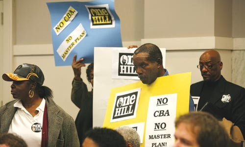 One Hill members protest arena development plans at a planning commission meeting. - HEATHER MULL