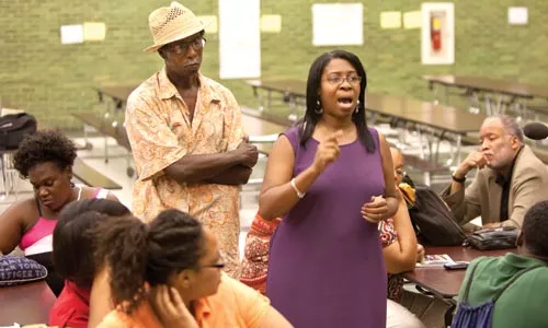 Parent Donna Simms-Key sounds off at a July 20 community meeting about the Pittsburgh School District's plans to close and consolidate several schools in the area. - JOHN ALTDORFER