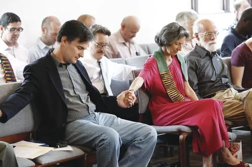 Pastor Mark Elias (in dark suit), founder of the Open Door Worship Center, in Bellflower, Calif., joins about 100 attendees during a June 5 InterFaith Pride Service. - HEATHER MULL