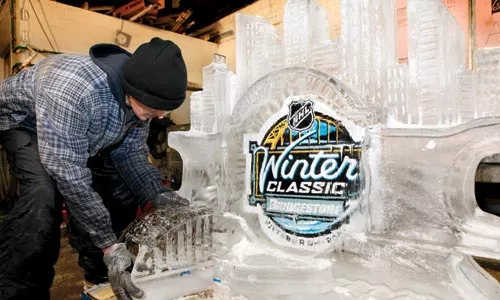 Playing it Cool: In the ice-sculpting room of Mastro Ice, on Herron Avenue in the Hill District, Kevin Heist, 40, of Chippewa, puts the finishing touches on a 500-pound NHL Winter Classic ice sculpture. The sculpture will be installed at Heinz Field on Saturday, and Mastro Ice will be producing numerous other sculptures - including an 8-by-4-foot Zamboni machine - which will be on display throughout the day. - HEATHER MULL