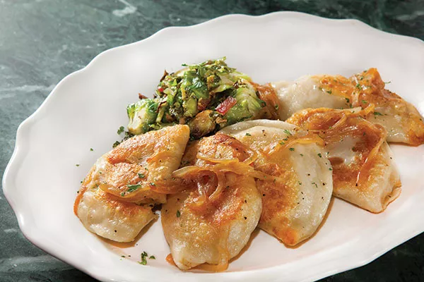 Potato-and-cheese pierogis with caramelized onions and Brussels sprouts with bacon - PHOTO BY HEATHER MULL