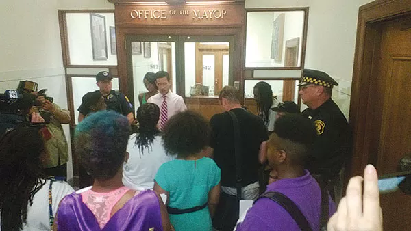 Protesters speak to mayoral staffer Jim Sheppard during a demonstration outside the mayor's office in the wake of the George Zimmerman verdict. - PHOTO BY CHRIS POTTER