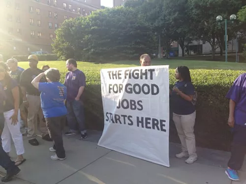 Protestors gather with signs on Centre Ave.