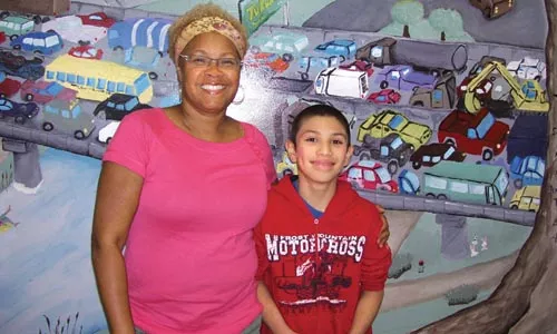 Sharon Flake with a young fan.