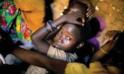 Suffer the children: In Ron Haviv's "Gina" (2005), a girl and her family mourn an 11-month-old child who died from disease.