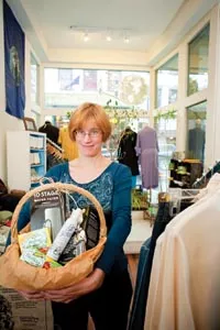 Tanya Kavalkovich, manager and buyer of E House Company, presents a basket of - environmentally-friendly items. - RENEE ROSENSTEEL