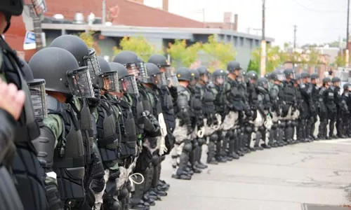 Thick blue line: Officers in full riot gear, before a Sept. 24, 2009 confrontation with protesters in Lawrenceville - CHARLIE DEITCH