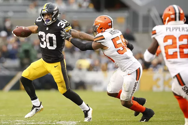 Conner found many holes in the defense while also working for his yardage like he did here against Christian Kirksey #58 of the Cleveland Browns. - CP PHOTO: JARED WICKERHAM