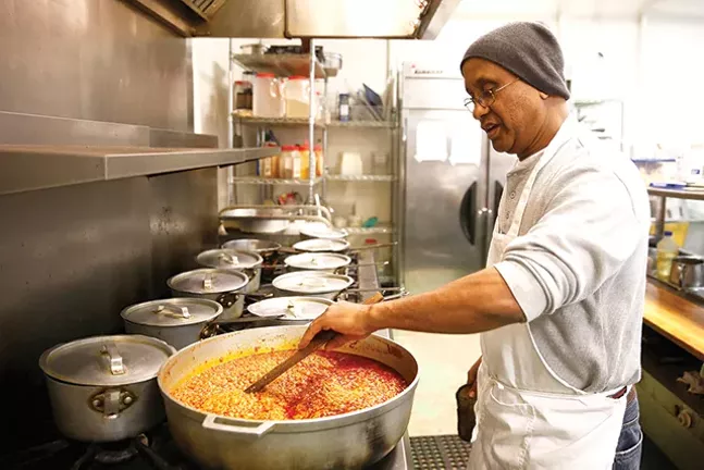 Owner Seifu Haileyesus prepares a sampler of various meats and vegetables. - CP PHOTO: JARED WICKERHAM