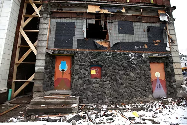 Condemned buildings are torn down next to the Garden Theater on the North Side. - CP PHOTO: JARED WICKERHAM