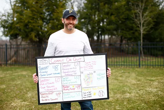 Jeff Verszyla holding his WhiteBoard Weather forecast in his North Hills backyard. - CP PHOTO: JARED WICKERHAM