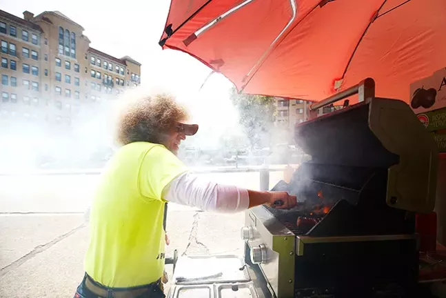 Owner John Spellman of The Shady Dog serves up hot dogs at his food cart in Shadyside. - CP PHOTOS: JARED WICKERHAM