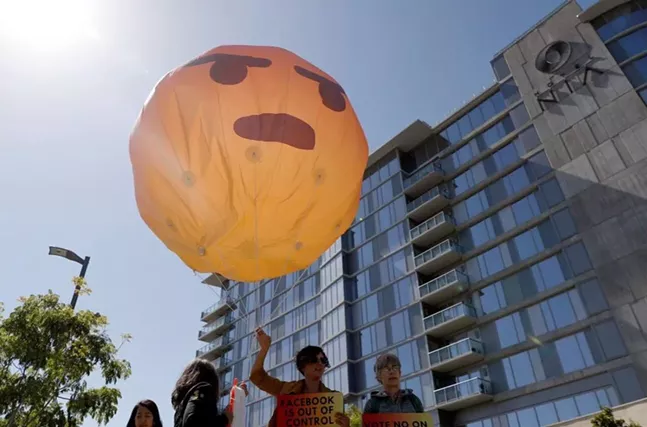 Large balloon held by Sum of Us organizers outside Facebook offices in California in May - PHOTO: ARIELLE COHEN