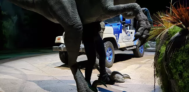 The actor who manipulates Blue the velociraptor legs popping out from the bottom of the suit - CP PHOTO: JOSH OSWALD