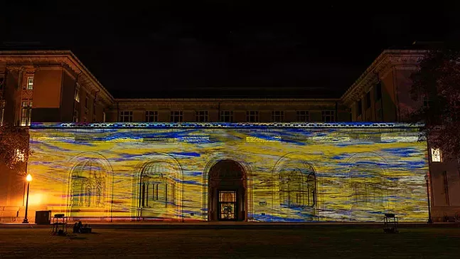 An explosion of light and imagery blasting onto the College of Arts façade from Mendi and Keith Obadike’s sound-light performance, Book of Light. - PHOTO: WATS:ON? FESTIVAL