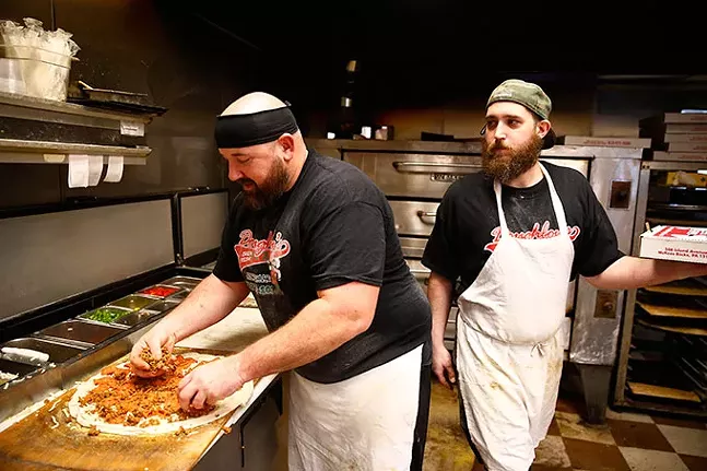 Owner Ryan Neal and manager Ross Yakubik prepare pizzas at Doughboy's Pizza. - CP PHOTO: JARED WICKERHAM