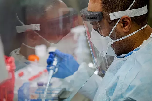 Pennsylvania Commonwealth microbiologist Kerry Pollard performs a manual extraction of the coronavirus inside the extraction lab at the Pennsylvania Department of Health Bureau of Laboratories on Fri., March 6, 2020. - OFFICIAL PA. GOVERNMENT PHOTO