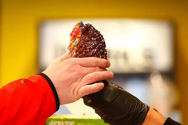 Galen Moorer, Jr., owner of Happy Day Dessert Factory, hands off ice cream cones to a customer. - CP PHOTO: JARED WICKERHAM