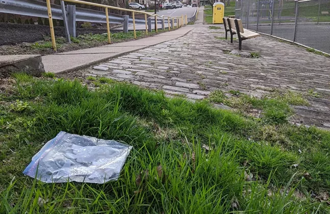 A plastic Ziploc bag full of latex PPE gloves outside of Heth's Park in Morningside - CP PHOTO: AMANDA WALTZ