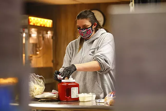 Karen Karmazin puts together a to-go order at the Riverside Drive In Theatre on Sat., May 9, 2020 in Vandergrift, Pa. - CP PHOTO: JARED WICKERHAM