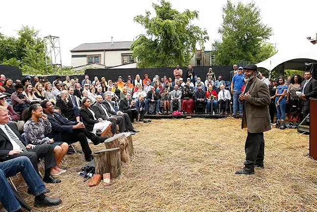Pittsburgh actor Wali Jamal, who has performed in all of August Wilson's plays, laughed with Jamaica Johnson while Allegheny County Executive Rich Fitzgerald looked on following her performance during a community groundblessing featuring Denzel Washington at the August Wilson House in the Hill District on Wed., Sept. 26, 2018. - CP PHOTO: JARED WICKERHAM