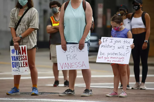 Protesters hold up signs outside of the Federal Building on Liberty Avenue in Downtown Pittsburgh marching for Vanessa Guillen. - CP PHOTO: JARED WICKERHAM