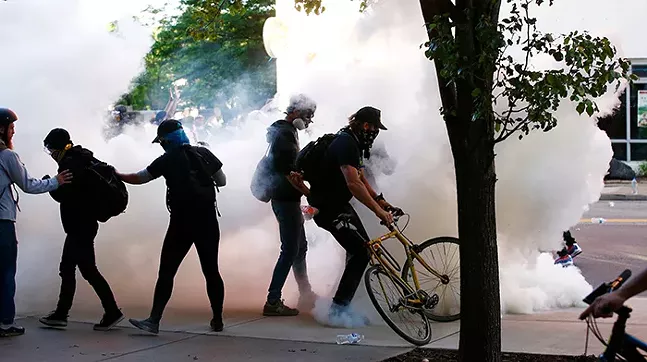 Protesters among tear gas fired by Pittsburgh Police on Centre Avenue during a march in the East Liberty on June 1 - CP PHOTO: JARED WICKERHAM