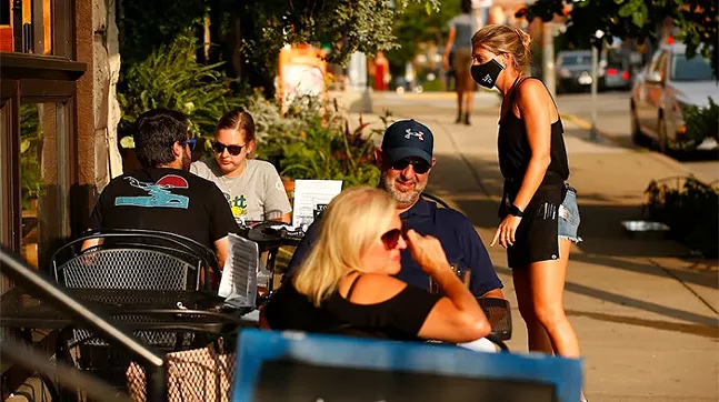 Alexa Namestnik waits on tables outside of Lot 17 in Bloomfield on Tue., July 21. - CP PHOTO: JARED WICKERHAM