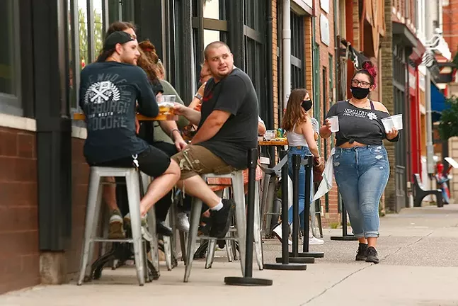 Patrons dine outside of Industry Public House in Lawrenceville on Tue., July 21. - CP PHOTO: JARED WICKERHAM
