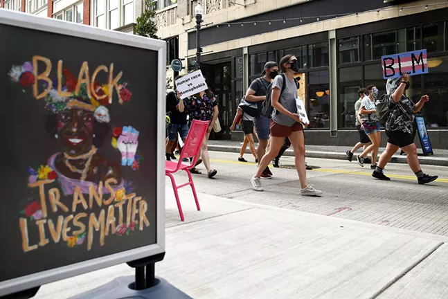 A "Black Trans Lives Matter" sign is seen as protesters walk by Millie's Ice Cream near Market Square. - CP PHOTO: JARED WICKERHAM