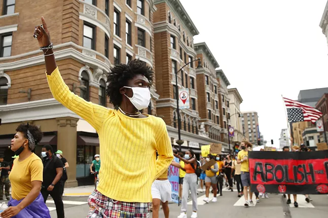 Black, Young, and Educated co-founder, Nicholas Anglin, marches along Forbes Avenue in Oakland. - CP PHOTO: JARED WICKERHAM