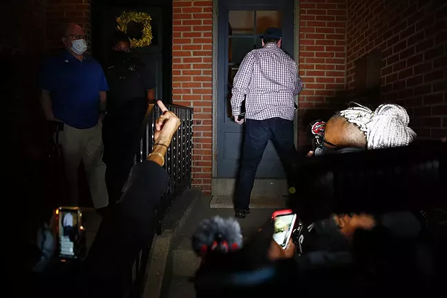 Pittsburgh Mayor Bill Peduto returns into his house after an exchange with protesters ends in an impasse. - CP PHOTO: JARED WICKERHAM