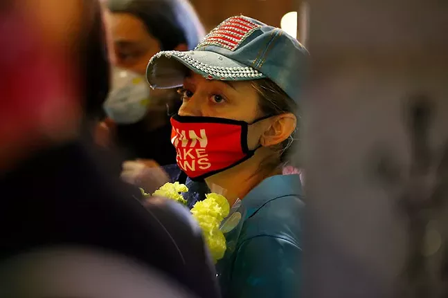 A protester who appears to be Brittany Acosta, wearing a "CNN Fake News" mask, in Downtown Pittsburghon Wed., Nov. 4. - CP PHOTO: JARED WICKERHAM