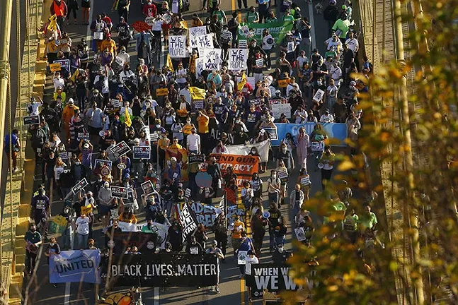 Pittsburghers march across the 10th Street Bridge on their way from South Side to Downtown as part of Alliance for Police Accountability and PA United’s “Every Voice Heard, Every Voice Counted” celebration following Biden-Harris’ projected win on Sat., Nov. 7. - CP PHOTO: JARED WICKERHAM